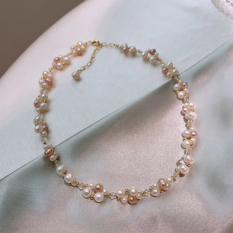 Luminous Dreams Set necklace with natural freshwater pearls and crystals on 14K gold-filled chain, displayed on satin fabric.