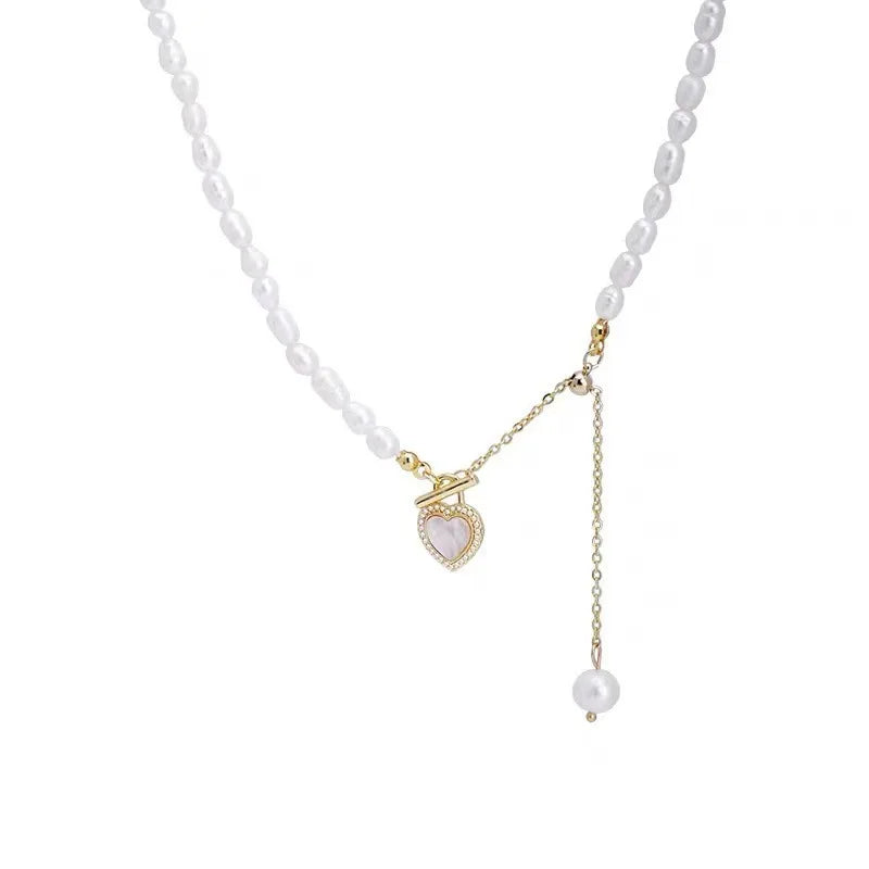 Product image of Pearl of My Heart Necklace with baroque pearls, gold chain, and heart charm, ideal for romantic and elegant styling.