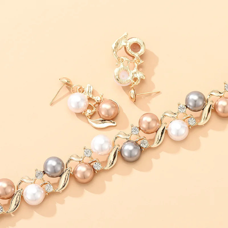 Close-up of Royal Serenity Set for Women showing intricate pearl and gold detailing on the necklace and earrings against a peach backdrop.