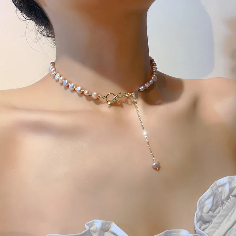 Model wearing Pink Baroque Pearl Gold-Filled Necklace with toggle clasp and drop chain, highlighting its romantic and feminine design.