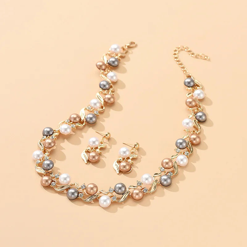 Royal Serenity Set for Women includes a pearl necklace and earrings with gold accents, displayed on a beige background for elegant appeal.